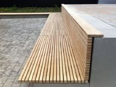 a wooden bench sitting on top of a sidewalk