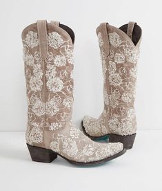 a pair of cowboy boots with white flowers on them