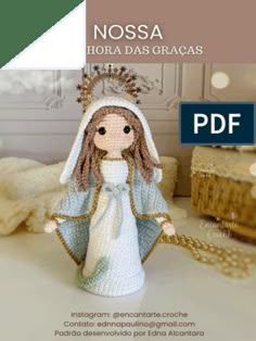 a crocheted doll with a white dress and bonnet on it's head