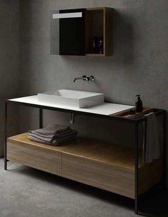 a bathroom with a sink, mirror and towel rack