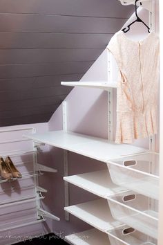 an organized closet with white shelves and shoes