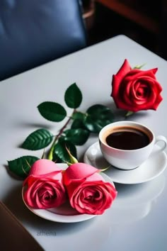 two roses and a cup of coffee on a table