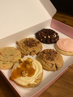 an open box filled with different types of cookies