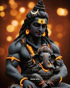 a statue of the hindu god ganesh with an elephant in his lap is shown