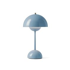 a blue table lamp sitting on top of a white floor