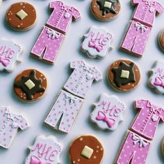 cookies decorated with pink and brown baby clothes