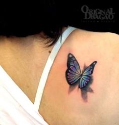 a woman's shoulder with a butterfly tattoo on her left side ribcage