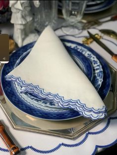 a blue and white place setting on a table