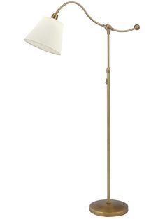 a floor lamp with a white shade on the base and a gold colored metal pole