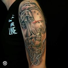 a man's arm with a clock and wrench tattoo design on the arm