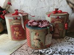 three tin canisters sitting on top of a table