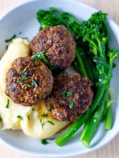 some meatballs and broccoli on a white plate