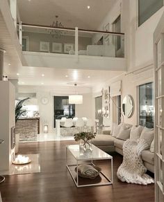 a living room filled with furniture and lots of windows