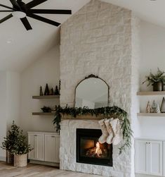 a living room with a fire place and christmas decorations