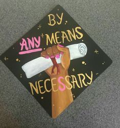 a decorated graduation cap that says by any means necessary