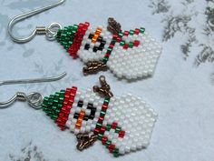 two snowmen made out of legos sitting next to each other