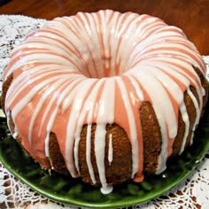 a bundt cake with icing on a green plate