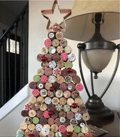 a christmas tree made out of wine corks on a table next to a lamp