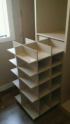 an empty shelf in the corner of a room