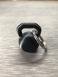 a black kettle ring sitting on top of a wooden table