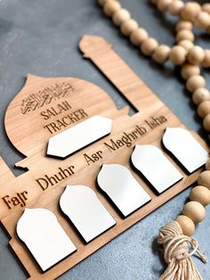 a wooden bead and tassel with the names of different countries on it next to a rosary