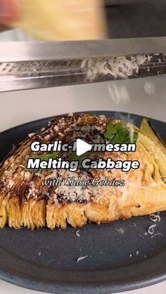 a close up of a plate of food on a microwave with the words garlic and mezzan melting cabbage