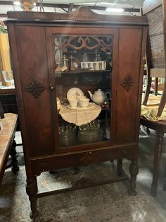 an antique china cabinet with glass doors