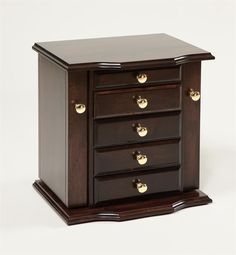 a wooden jewelry box with three drawers and gold knobs on the front, sitting on a white surface