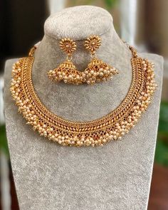 Gold Necklace/ Indian Jewelry/ Indian Necklace/ Adjustable Gold plated Pearl Necklace/ Indian Gold Necklace Set/ Indian Wedding Jewelry Gorgeous 22 K gold plated. Perfect for Indian weddings. Size- Adjustable All the raw material used in this product is of high quality and is handcrafted with love. Premium Quality and High craftsmanship 100% Satisfaction Guarantee: Long Lasting Plating, High-Quality Stones. Gifting: This pair of charming necklace and earrings come in a beautiful gift box, making Choker Necklace Indian Gold, Indian Gold Necklace Set, Gold Choker Necklace Indian, Gold Necklace Set Indian, Pearl Necklace Indian, Indian Gold Necklace, Choker Necklace Indian, Guttapusalu Necklace, Choker Pearl Necklace