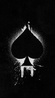 a black and white image of two playing cards in the dark with light coming from behind it