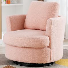 a pink chair sitting on top of a rug