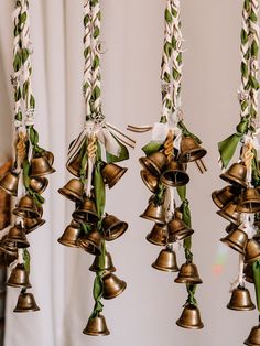 several bells hanging from the ceiling with ribbons