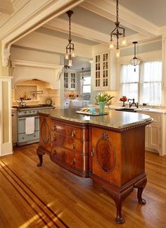 a large kitchen with an island in the middle