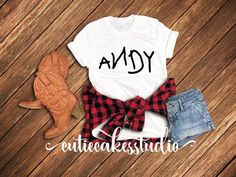 an adorable shirt that says andy on the front and plaid bow tie at the back