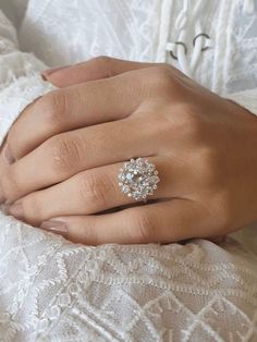 a woman's hand with a diamond ring on it