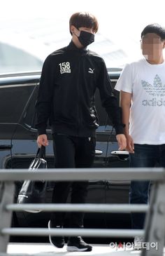 two men in black jackets and white t - shirts are holding hands