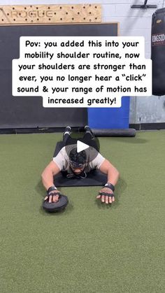 a man laying on top of a black mat in front of a punching bag with the caption'pov you added this into your mobility shoulder routine, now your shoulders are strong, no longer than