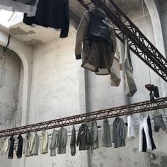 clothes hanging from the ceiling in an old building