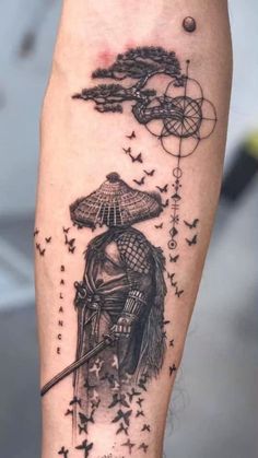 a person with a tattoo on their arm holding an umbrella and wearing a helmet that has birds flying around it