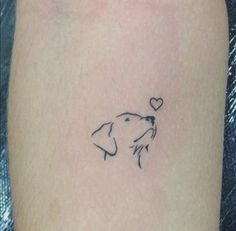 a dog with a heart tattoo on its leg