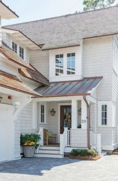 a white house with a brown metal roof