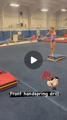 a woman standing on top of a skateboard next to another person in a gym