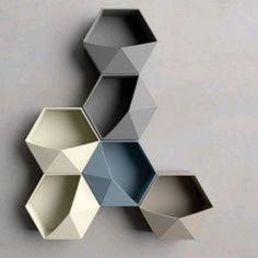 three hexagonal shaped shelves on the wall