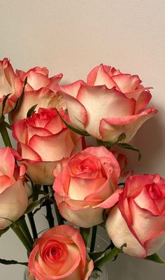 a vase filled with pink roses on top of a table