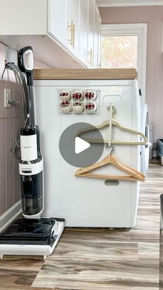 an image of a kitchen setting with clothes hanging on the rack and wine glass holder