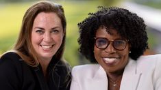 two women sitting next to each other smiling