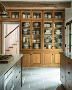 a kitchen filled with lots of wooden cabinets