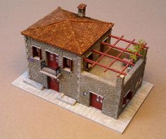 a small model house with a red roof