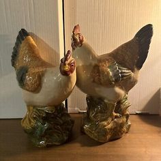 two ceramic chickens sitting next to each other