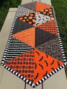 an orange and black table runner with bats on it